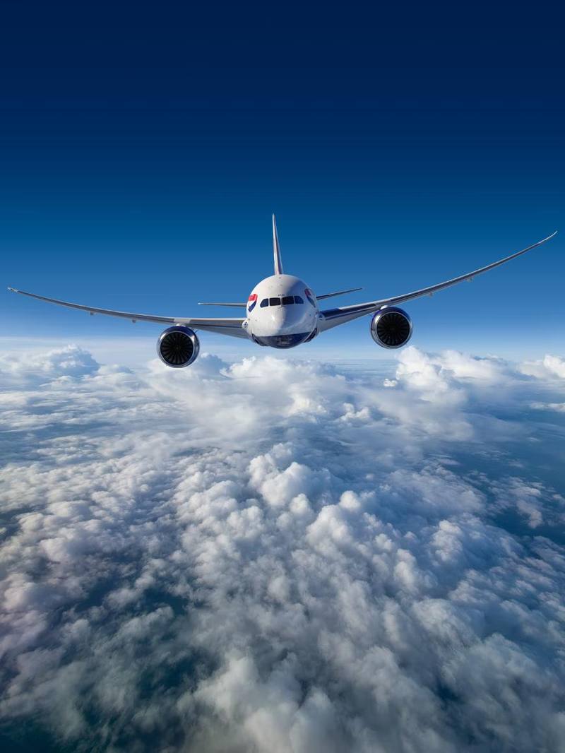 Aircraft head-on above clouds